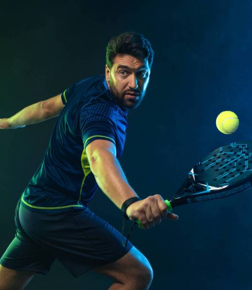 Padel tennis player with racket. Man athlete with racket on court with neon colors. Sport concept. Download a high quality photo for the design of a sports app or betting site